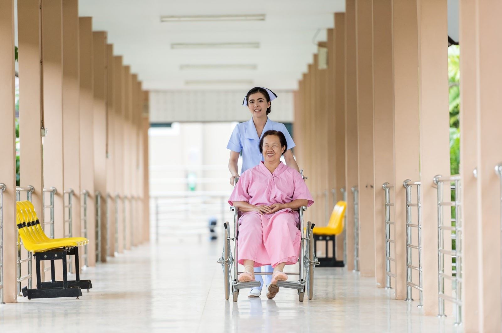 nurse walking with elderly woman